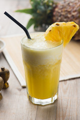 fresh pineapple juice with wooden background