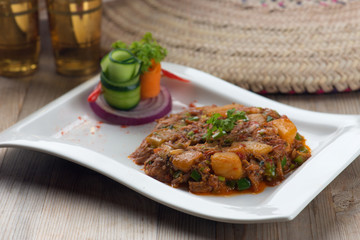 oqda popular arab food, fried potatoes with meat