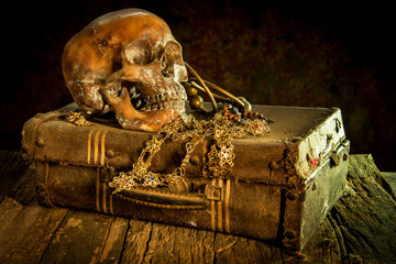 Still life with a human skull with old treasure chest and gold,