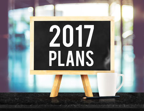 2017 plans on blackboard with easel on black marble table with c