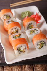 Serving Philadelphia rolls with wasabi and ginger close-up. vertical 
