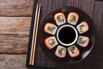 Sushi roll philadelphia and soy sauce, closeup. Horizontal top view
