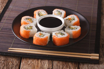Roll Philadelphia made of Fresh Salmon, Cream Cheese and Avocado. Horizontal

