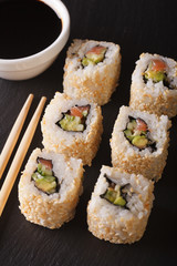Japanese cuisine: california rolls and soy sauce closeup. vertical top view
