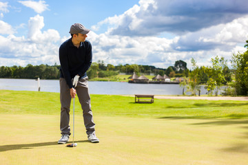 Male golf player, wonderful cloud formation in background.