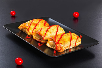 crepes stuffed with minced meat  poured with томато sauce