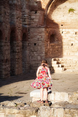 Fototapeta na wymiar Girl walking among the ruins