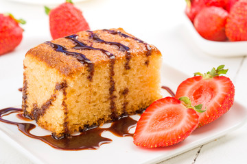 sweet cake with cut strawberry on table