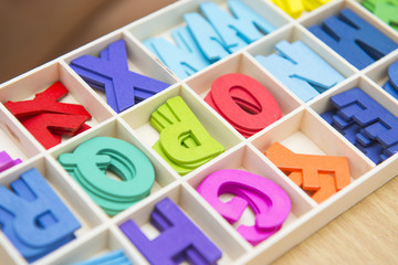 Colorful wooden english letters in box
