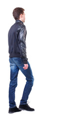 Back view of going  handsome man. walking young guy . Rear view people collection.  backside view of person.  Isolated over white background. Curly guy in a black leather jacket goes sideways.
