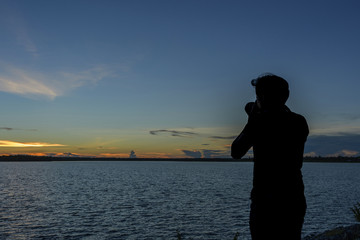 Fototapeta premium Silhouette of male person camera hold