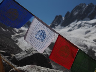 colorfull buddist nepal flags on the background of snowy mountains