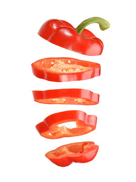 sliced and falling red pepper isolated on white background