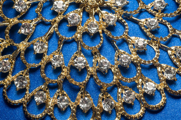 Golden Necklace on Blue Background