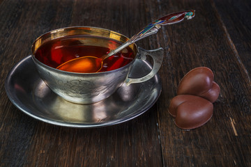 Black tea in vintage silver cup