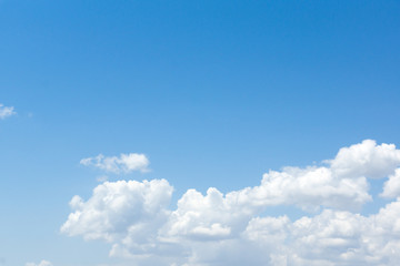 the white clouds floating on a background of blue sky