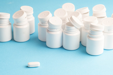 Many pills and tablets isolated on light blue background