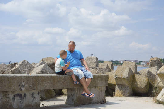 son talking to his father on the beach