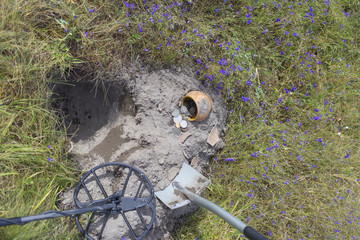 Treasure ancient coins dug out of the ground.