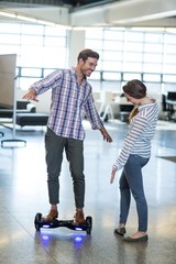 Graphic designer standing on hoverboard