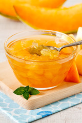 Cantaloupe melon jam in a glass bowl on a table