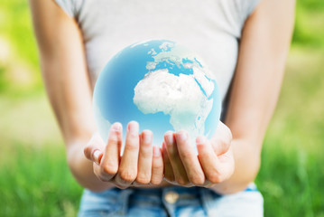 Woman holding planet Earth in her hands