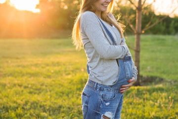 Young pregnant woman in nature