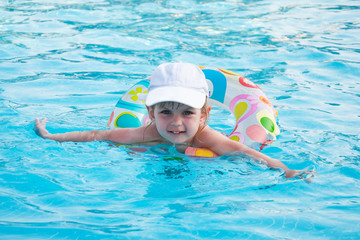 little girl swims in a pool