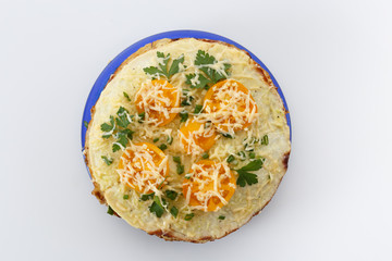 Vegetable cake with zucchini, tomatoes, cheese, onions and garlic served on plate