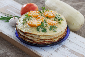 Vegetable cake with zucchini, tomatoes, cheese, onions and garlic served on plate