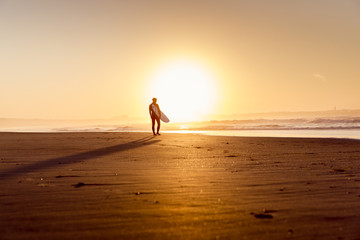 Fototapeta na wymiar Surfers on the beach