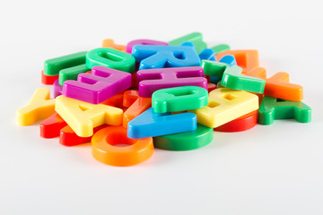 Colorful plastic alphabet letters on white background