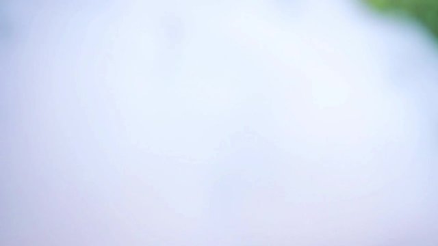 young vaper man exhaling big clouds of smoke with e-cigarette vape in slowmotion