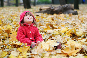 little girl in yellow leaves