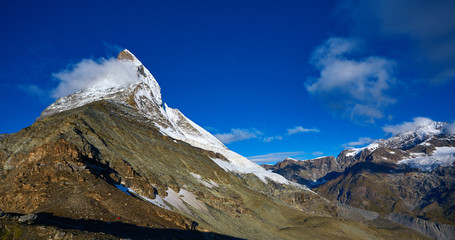 Snow capped mountains. Matterhorn mount in the clouds at early morning. view of the north- eastern ridge . Trek near Matterhorn mount.