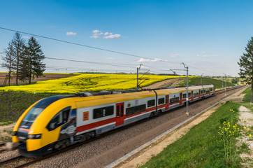 Obraz premium Train on double railway track, Krakow, Poland
