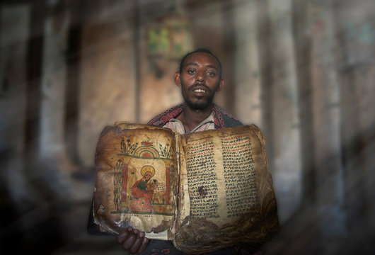 Priest showing an ancient religious book in an orthodox monastery, Tigray, Ethiopia