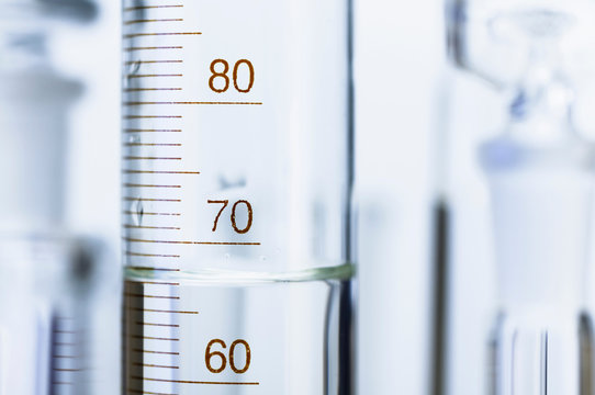 Chemical glassware. Graduated cylinder and other out-of-focus chemical lab glassware