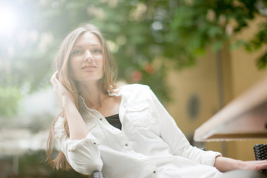 Beautiful woman relaxing at sidewalk cafe, Freiburg, Germany