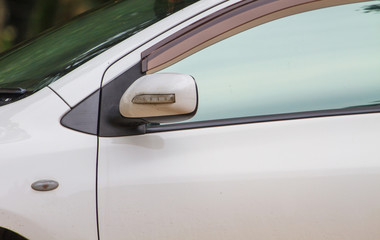 Wing mirror on a white car