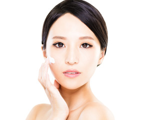 Obraz na płótnie Canvas Beautiful women applying moisturizer cosmetic cream on face