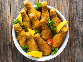 Fried chicken drumstick  on wooden background.