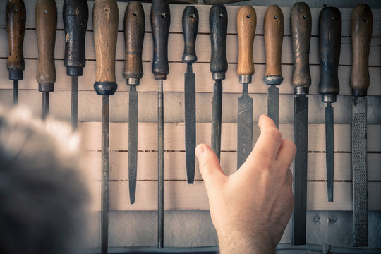 Man taking chisel from rack