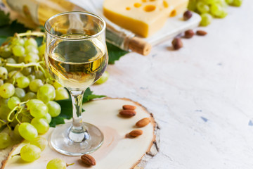 White wine in a glass on a white background, copy space