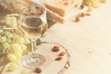 Vintage background with a glass of white wine and grapes, tinted