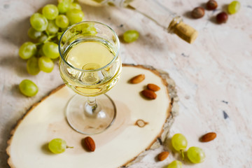Glass of white wine and a bunch of grapes