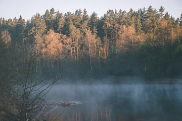 Obraz premium beautiful foggy river in forest - vintage film effect