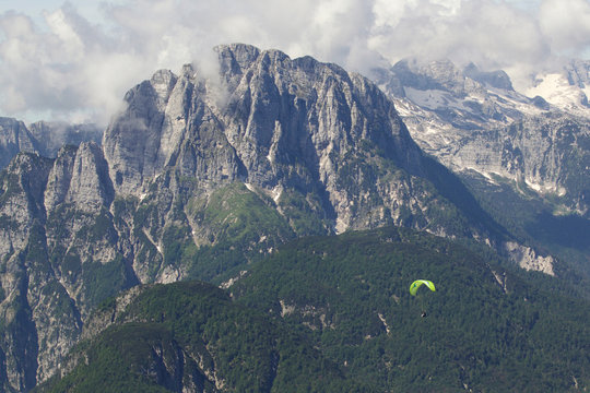 Lone paraglider paragliding in Julian Alps, Bovec, Slovakia