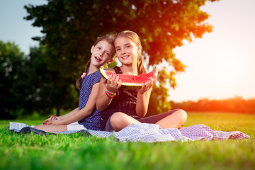 Cute girls eating watermelon