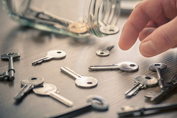 Man's hand picking up keys